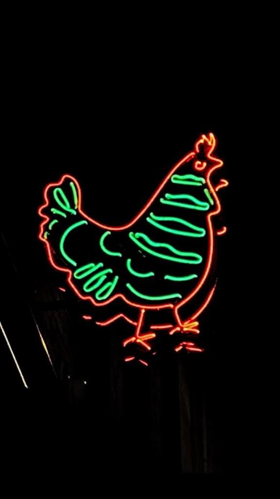 Chicken neon sign using orange and green lights